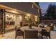 Backyard patio with folding doors that seamlessly connect outdoor and indoor spaces, surrounded by cozy seating at 11861 E Yale Ct, Aurora, CO 80014