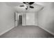 Neutral bedroom with ceiling fan, closet and ensuite door at 11861 E Yale Ct, Aurora, CO 80014