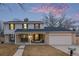 Charming two-story home featuring well-maintained landscaping, a covered porch, and an attached garage at 11861 E Yale Ct, Aurora, CO 80014