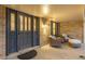 Inviting covered front porch with seating area, brick accents, and decorative front door with leaded glass at 11861 E Yale Ct, Aurora, CO 80014