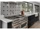 Gourmet kitchen featuring stainless steel appliances, patterned backsplash, and abundant counter space at 11861 E Yale Ct, Aurora, CO 80014