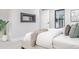 Bright bedroom featuring a modern fireplace, soft bedding, and stylish decor at 11861 E Yale Ct, Aurora, CO 80014