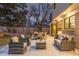 Inviting outdoor patio with comfortable seating, dining table, and well-maintained landscaping at 11861 E Yale Ct, Aurora, CO 80014