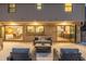 Well-lit patio with plush seating, seamlessly connecting indoor and outdoor living spaces through glass doors at 11861 E Yale Ct, Aurora, CO 80014
