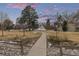 Scenic community walking path winding through landscaped grounds with mature trees at 11861 E Yale Ct, Aurora, CO 80014