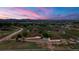 Property with a ranch house and detached garage on a large lot with surrounding mountain view and a scenic sky at 1851 E 138Th Ave, Brighton, CO 80602
