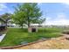 A stone fireplace sits in the backyard of this home, in a landscaped lawn at 1851 E 138Th Ave, Brighton, CO 80602
