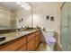 Bathroom featuring a granite countertop vanity, a toilet, and a walk-in shower at 1851 E 138Th Ave, Brighton, CO 80602