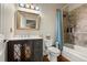 Traditional bathroom with tile shower, blue shower curtain, and classic vanity at 1851 E 138Th Ave, Brighton, CO 80602