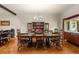 Formal dining room with a wooden table, chairs, hardwood floors, and a china cabinet at 1851 E 138Th Ave, Brighton, CO 80602