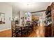 Open concept dining room featuring a dark wood table set and hardwood floors at 1851 E 138Th Ave, Brighton, CO 80602