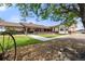 Ranch-style home with brick accents, a covered porch, and walkway through the landscaped yard at 1851 E 138Th Ave, Brighton, CO 80602