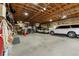 A large garage with an expansive work area, two vehicles, and a variety of tools at 1851 E 138Th Ave, Brighton, CO 80602