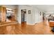 Hallway entrance with hardwood floors leading to dining area, pantry, and sitting room at 1851 E 138Th Ave, Brighton, CO 80602