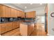 Updated kitchen with wooden cabinets, an island, granite countertops, and stainless appliances at 1851 E 138Th Ave, Brighton, CO 80602