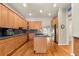 Bright kitchen featuring wooden cabinets, a center island, and stainless steel appliances at 1851 E 138Th Ave, Brighton, CO 80602