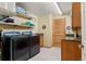 Well-lit laundry room with modern washer and dryer and ample storage space at 1851 E 138Th Ave, Brighton, CO 80602