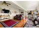 Comfortable living room featuring hardwood floors, ceiling fan, and cozy seating area at 1851 E 138Th Ave, Brighton, CO 80602