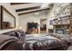 Spacious living room with a stone fireplace, high ceilings, and comfortable leather seating at 1851 E 138Th Ave, Brighton, CO 80602