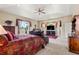 Relax in the ample bedroom featuring a plush bed, ceiling fan, and natural light at 1851 E 138Th Ave, Brighton, CO 80602