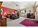 This large bedroom features a seating area, ceiling fan, and large window to enjoy the morning sun at 1851 E 138Th Ave, Brighton, CO 80602