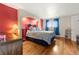 Spacious main bedroom with an arched alcove, hardwood floors, and a large window at 1851 E 138Th Ave, Brighton, CO 80602