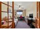 Office room with a cozy couch, a large window, a desk, and a ceiling fan at 1851 E 138Th Ave, Brighton, CO 80602
