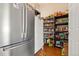 Walk-in pantry with ample shelving and storage space, including additional refrigerator at 1851 E 138Th Ave, Brighton, CO 80602