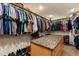 Spacious walk-in closet with custom shelving, hanging rods, and a central island at 1851 E 138Th Ave, Brighton, CO 80602