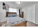 Cozy bedroom with wood-toned furniture and patterned bedding at 8541 Corona St, Denver, CO 80229