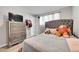 Spacious bedroom with gray upholstered bed and a dresser at 8541 Corona St, Denver, CO 80229