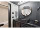 Bathroom with a black vessel sink and wall mirror at 550 E 12Th Ave # 810, Denver, CO 80203