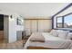Bright bedroom with a large window and a custom closet with sliding doors at 550 E 12Th Ave # 810, Denver, CO 80203