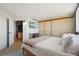 Comfortable bedroom with wood floors, mounted tv, and a view of the bar and coffee area at 550 E 12Th Ave # 810, Denver, CO 80203