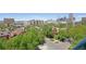 Stunning city view featuring vibrant greenery and brick buildings in a neighborhood setting under a clear blue sky at 550 E 12Th Ave # 810, Denver, CO 80203