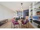 Open concept dining area near a kitchen with blue cabinets and modern shelving at 550 E 12Th Ave # 810, Denver, CO 80203