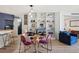 Open dining area next to living space with modern decor and built in shelving at 550 E 12Th Ave # 810, Denver, CO 80203
