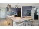 Modern kitchen featuring gray cabinets, herringbone backsplash, and wood island at 550 E 12Th Ave # 810, Denver, CO 80203