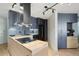 Modern kitchen featuring gray cabinets, herringbone backsplash, and wood island at 550 E 12Th Ave # 810, Denver, CO 80203