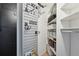 Storage area with white shelving, storage hooks and a black pegboard wall at 550 E 12Th Ave # 810, Denver, CO 80203