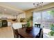 Bright dining area with sliding glass doors leading to the backyard and an adjacent kitchen at 562 W Crestline Cir # 7D, Littleton, CO 80120