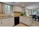 Bright kitchen with ample counter space, tile flooring, and black appliances at 562 W Crestline Cir # 7D, Littleton, CO 80120