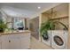 Laundry room next to open plan kitchen and dining area at 562 W Crestline Cir # 7D, Littleton, CO 80120