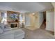 Cozy living room with brick fireplace, mounted television, plush carpeting, and neutral decor at 562 W Crestline Cir # 7D, Littleton, CO 80120