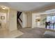 Open-concept living and dining area with carpet flooring, staircase, and neutral paint at 562 W Crestline Cir # 7D, Littleton, CO 80120