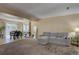 Bright living room with plush carpeting, sectional sofa, adjacent dining area, and natural light at 562 W Crestline Cir # 7D, Littleton, CO 80120