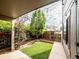 Backyard patio with a manicured lawn, garden beds, a wooden privacy fence, and decorative string lights at 1233 S Yosemite Way # 74, Denver, CO 80247