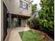 Relaxing backyard features string lights, artificial turf, concrete patio, and privacy at 1233 S Yosemite Way # 74, Denver, CO 80247