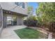 Private backyard featuring artificial turf, patio, mature landscaping and string lights at 1233 S Yosemite Way # 74, Denver, CO 80247