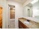 Bathroom featuring granite countertop, dark wood cabinets, large mirror, and a combined shower and tub at 1233 S Yosemite Way # 74, Denver, CO 80247